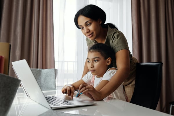 Child and mother on laptop