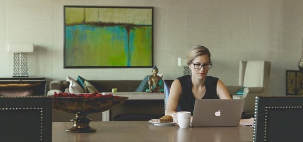 Woman at desk on Mac